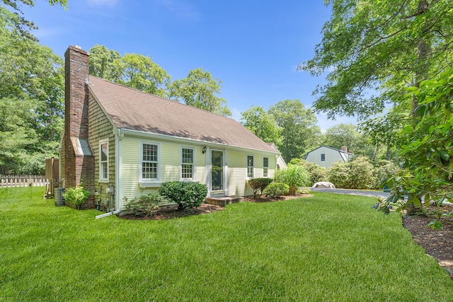 13 Old Fields Rd, Sandwich, MA 02563 - view of front of property with a front yard, a chimney, and roof with shingles