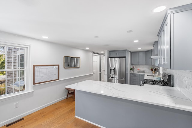 13 Old Fields Rd, Sandwich, MA 02563 - kitchen featuring stainless steel appliances, gray cabinetry, backsplash, light stone counters, and recessed lighting