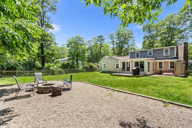 13 Old Fields Rd, Sandwich, MA 02563 - fenced backyard featuring an outdoor fire pit and a deck