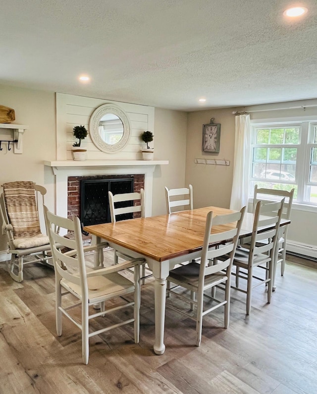19 Artisan Way, Forestdale, MA 02644 - dining room featuring a fireplace, recessed lighting, a textured ceiling, and wood finished floors