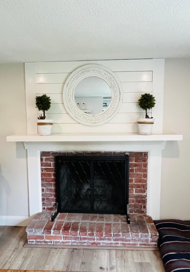19 Artisan Way, Forestdale, MA 02644 - interior details featuring baseboards, a fireplace, a textured ceiling, and wood finished floors