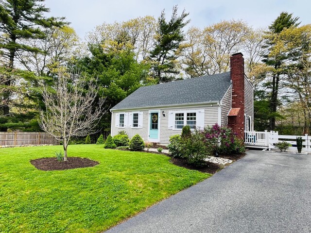 19 Artisan Way, Forestdale, MA 02644 - view of front of house with a front lawn, a shingled roof, a chimney, and fence