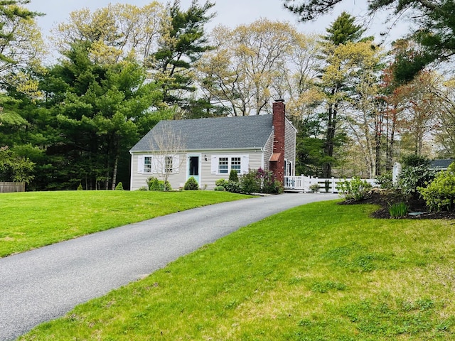 19 Artisan Way, Forestdale, MA 02644 - cape cod house with a front lawn, fence, and a chimney