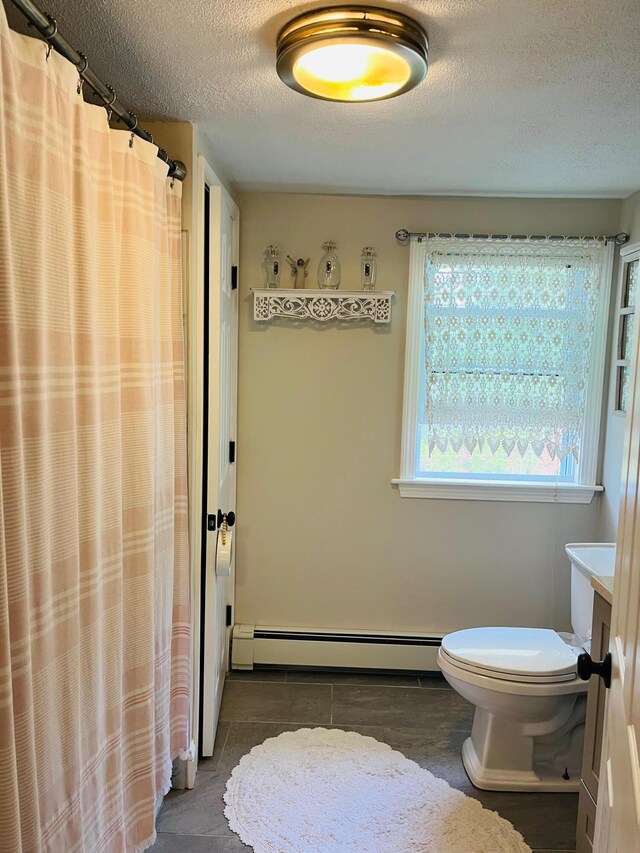 19 Artisan Way, Forestdale, MA 02644 - full bath with baseboard heating, a textured ceiling, toilet, a shower with shower curtain, and tile patterned floors