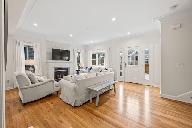 21 Priscilla Alden Rd Ua, Unit Ua, Provincetown, MA 02657 - living room featuring light wood-style floors, a fireplace, baseboards, and crown molding