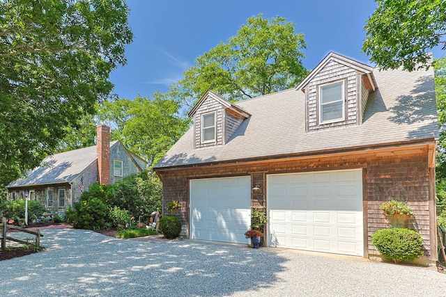 10 Bradford Ln, Eastham, MA 02642 - view of front of home with a garage and roof with shingles