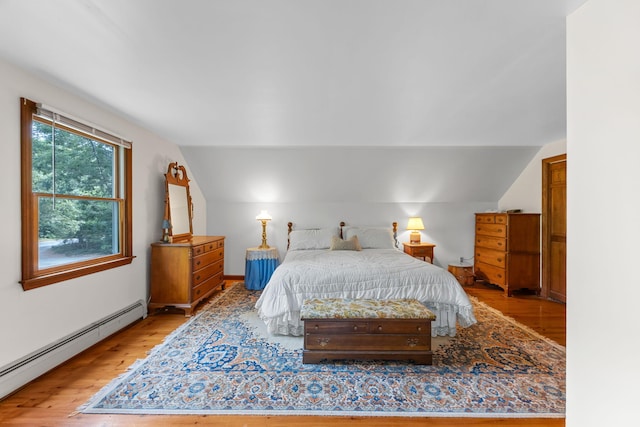 10 Bradford Ln, Eastham, MA 02642 - bedroom featuring a baseboard heating unit, wood finished floors, and vaulted ceiling