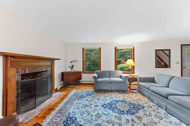 10 Bradford Ln, Eastham, MA 02642 - living area with light wood-style floors, a brick fireplace, and baseboard heating