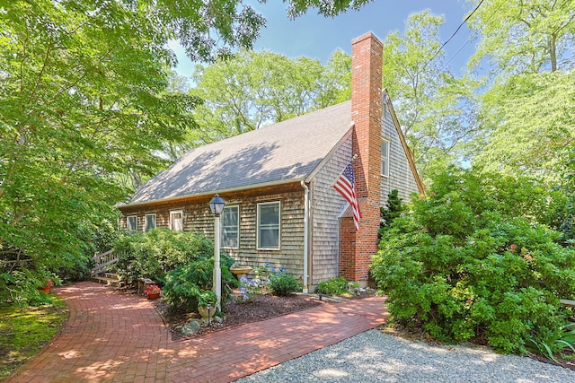 10 Bradford Ln, Eastham, MA 02642 - view of home's exterior featuring roof with shingles and a chimney