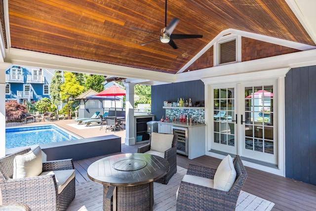 72 River Rd, Marstons Mills, MA 02648 - deck featuring wine cooler, an outdoor living space, an outdoor pool, exterior bar, and ceiling fan