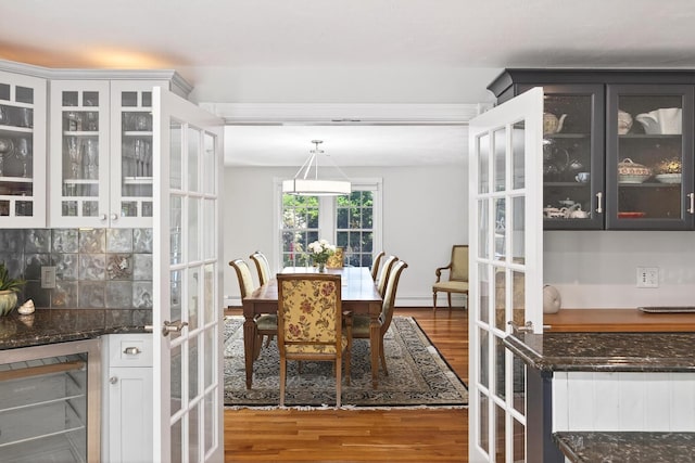 72 River Rd, Marstons Mills, MA 02648 - dining area with wine cooler, wood finished floors, a baseboard radiator, and french doors