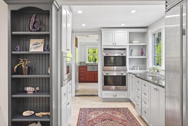 72 River Rd, Marstons Mills, MA 02648 - kitchen featuring open shelves, stainless steel appliances, dark stone counters, white cabinetry, and light tile patterned floors
