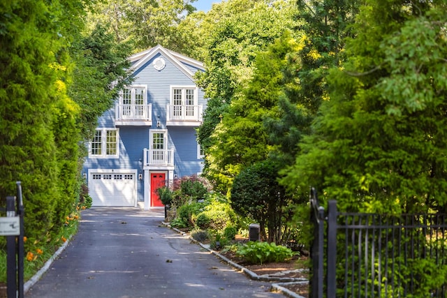 72 River Rd, Marstons Mills, MA 02648 - view of front of property with a balcony, asphalt driveway, and a garage