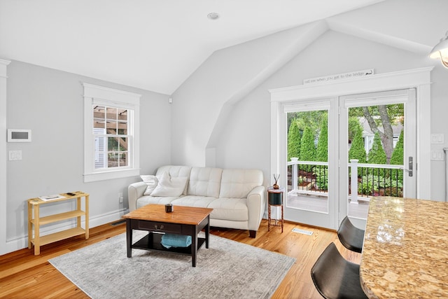 72 River Rd, Marstons Mills, MA 02648 - living area featuring vaulted ceiling, plenty of natural light, and light wood-type flooring