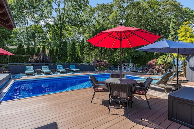 72 River Rd, Marstons Mills, MA 02648 - view of swimming pool with a wooden deck, view of scattered trees, and outdoor dining space