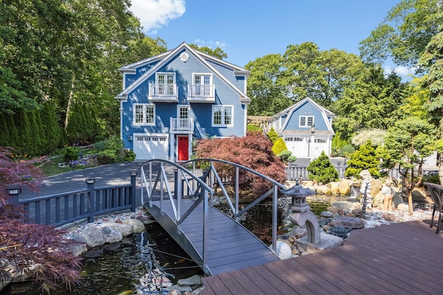72 River Rd, Marstons Mills, MA 02648 - rear view of house featuring a balcony and an attached garage