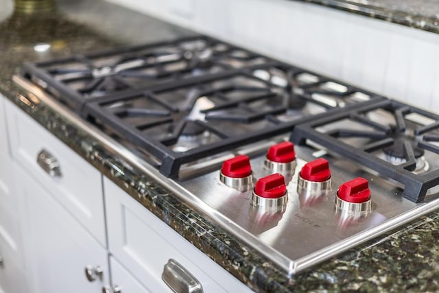 72 River Rd, Marstons Mills, MA 02648 - kitchen view of stainless steel gas cooktop and white cabinetry