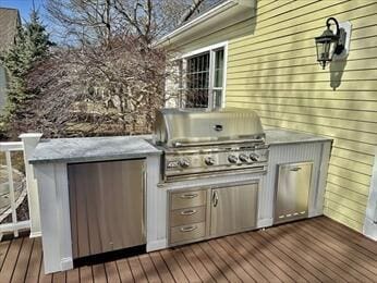 view of patio / terrace featuring grilling area, an outdoor kitchen, and a wooden deck