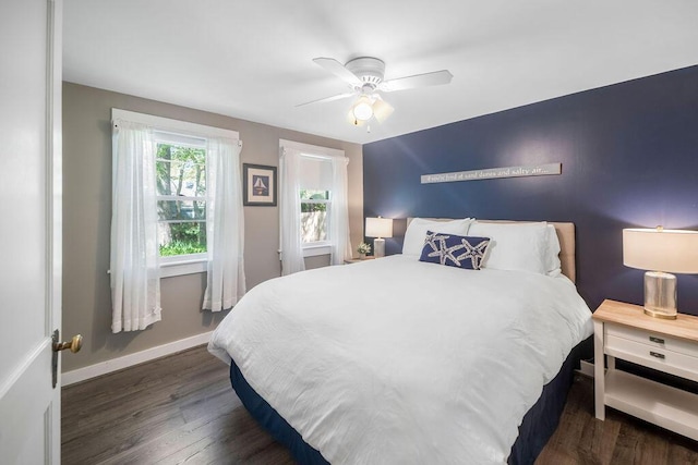 bedroom with wood finished floors, baseboards, and a ceiling fan