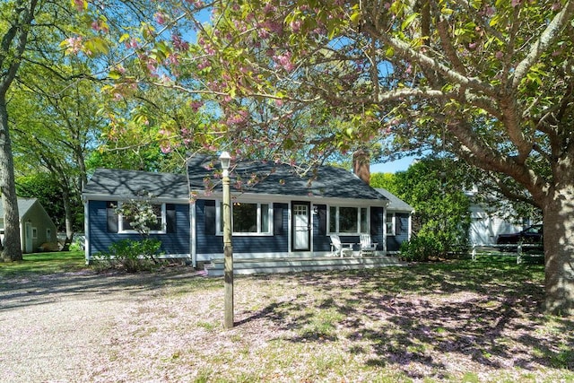 view of front of home with a porch and a chimney