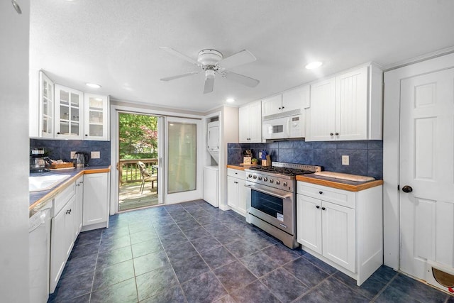 kitchen featuring white appliances, backsplash, glass insert cabinets, white cabinetry, and recessed lighting