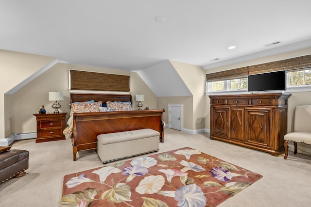 bedroom with light carpet, a baseboard heating unit, and lofted ceiling