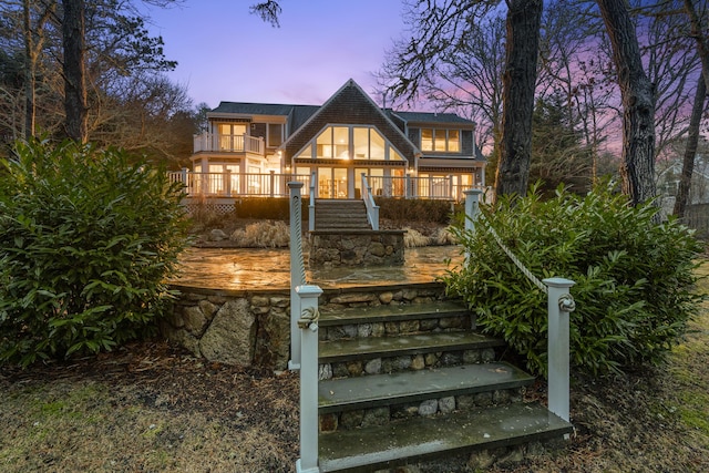 view of front of property with a balcony and a porch