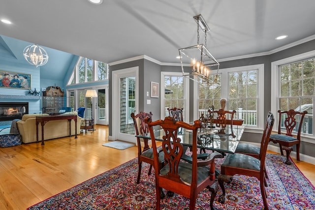 dining area featuring ornamental molding, plenty of natural light, a chandelier, and light hardwood / wood-style floors