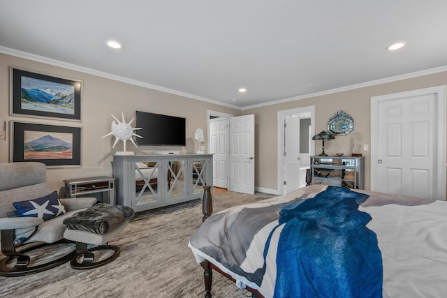 carpeted bedroom featuring ensuite bath and ornamental molding