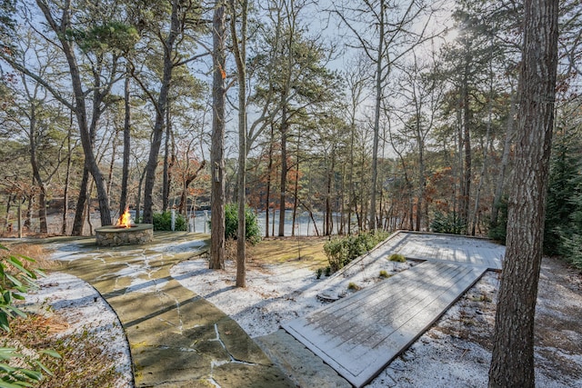 view of patio / terrace with a water view and an outdoor fire pit