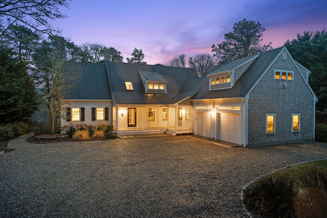 view of front of house featuring a porch and a garage