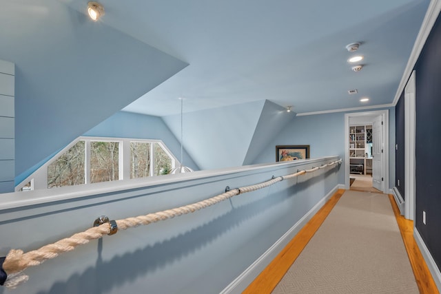 corridor with lofted ceiling and light hardwood / wood-style floors