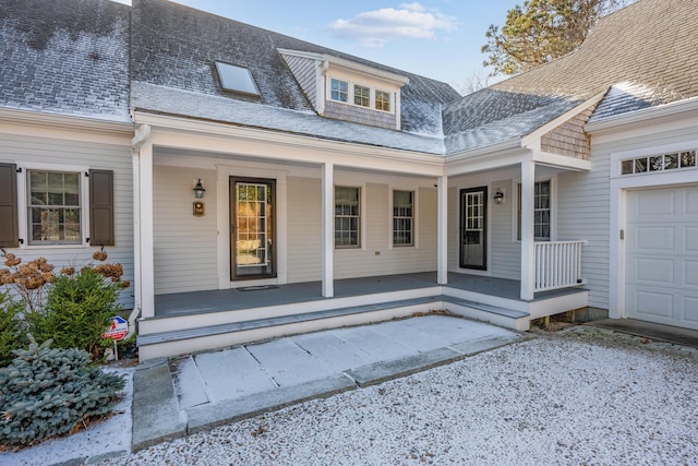 property entrance with a garage and covered porch