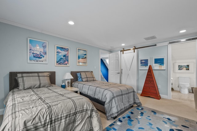 carpeted bedroom with ornamental molding and a barn door