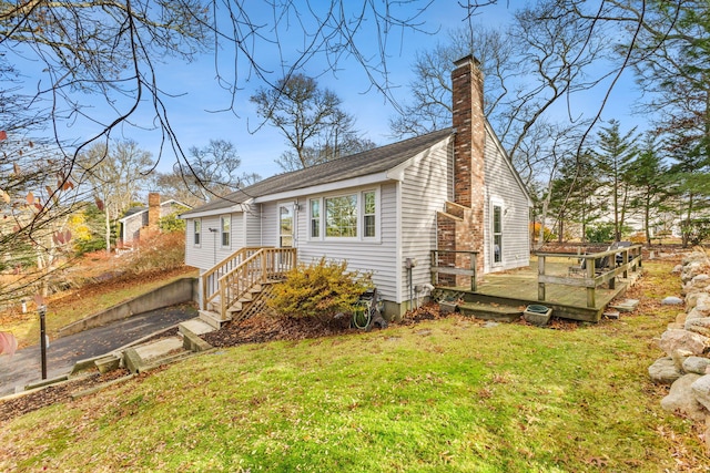 exterior space featuring a front lawn and a deck