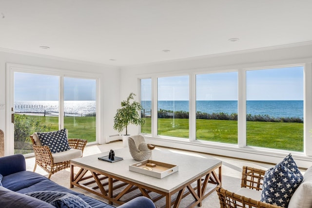 sunroom featuring a water view