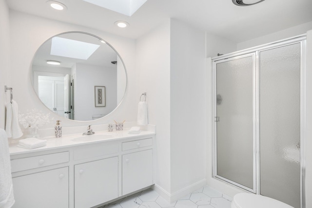 full bathroom with vanity, toilet, a stall shower, and tile patterned flooring