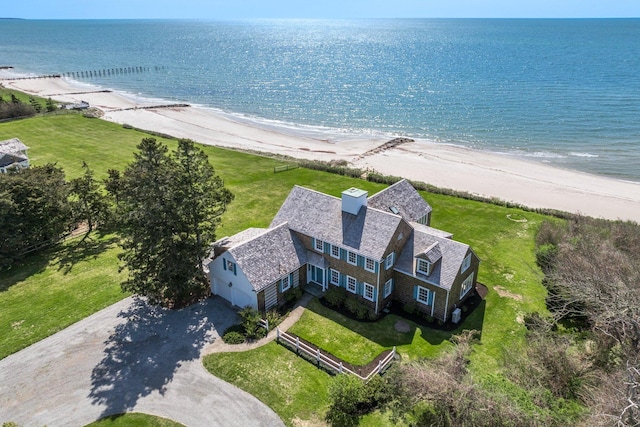 bird's eye view featuring a water view and a beach view
