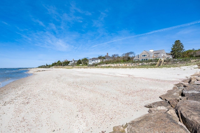 view of road featuring a water view and a beach view