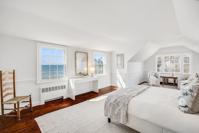 bedroom with hardwood / wood-style floors and radiator heating unit