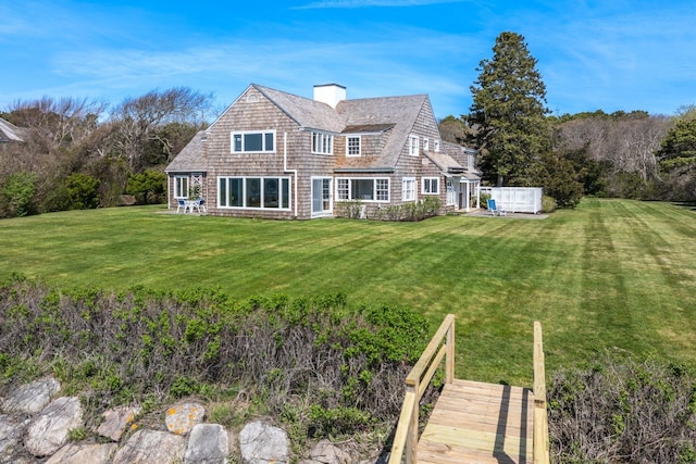 545 Sea View Ave, Osterville, MA 02655 - back of house with a chimney and a lawn