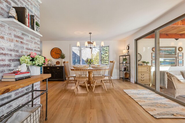 3 Bramblewood Ln, Orleans, MA 02653 - dining space with light wood-style flooring, baseboards, and an inviting chandelier