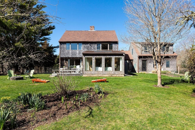 3 Bramblewood Ln, Orleans, MA 02653 - rear view of property with a yard, roof with shingles, and a chimney