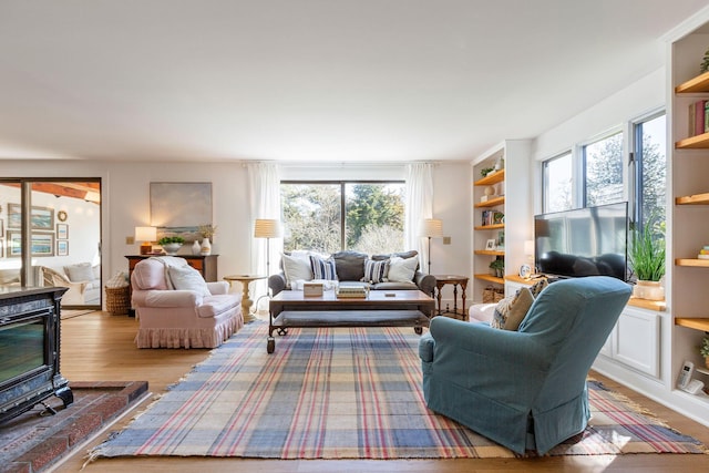 3 Bramblewood Ln, Orleans, MA 02653 - living room with wood finished floors, a wood stove, and built in features