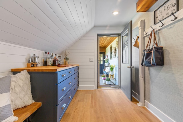 3 Bramblewood Ln, Orleans, MA 02653 - mudroom featuring vaulted ceiling, baseboards, light wood-style floors, and a bar