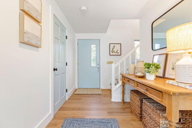 3 Bramblewood Ln, Orleans, MA 02653 - entrance foyer with light wood finished floors, baseboards, and stairway