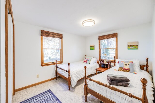 30 Overland Rd, Mashpee, MA 02649 - bedroom featuring multiple windows, light carpet, and baseboards