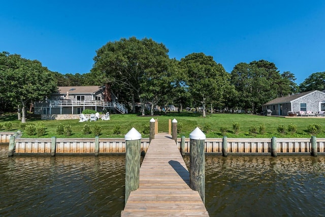 view of dock featuring a water view and a yard
