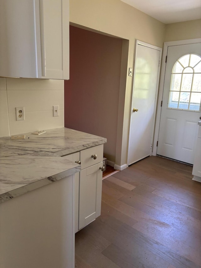 83 Partridge Valley Rd, West Yarmouth, MA 02673 - kitchen with dark wood-type flooring, white cabinets, and baseboards