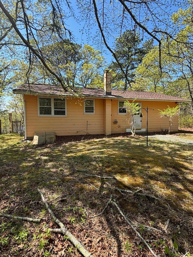83 Partridge Valley Rd, West Yarmouth, MA 02673 - rear view of house featuring a chimney and a yard